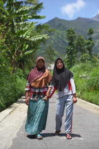 Tari and her Mum Wagiyem walking to school. Theoretically speaking Tari is now able to walk to school on her own, but to prevent her from receiving any bullying, Wagiyem happily accompanies her daughter.