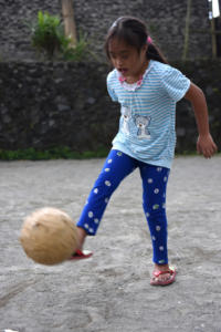 Cika playing soccer. Although the game is a little too quick for her, she enjoys it a lot and is good at sharing the ball.