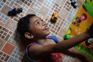 Moses at home playing with his cars.